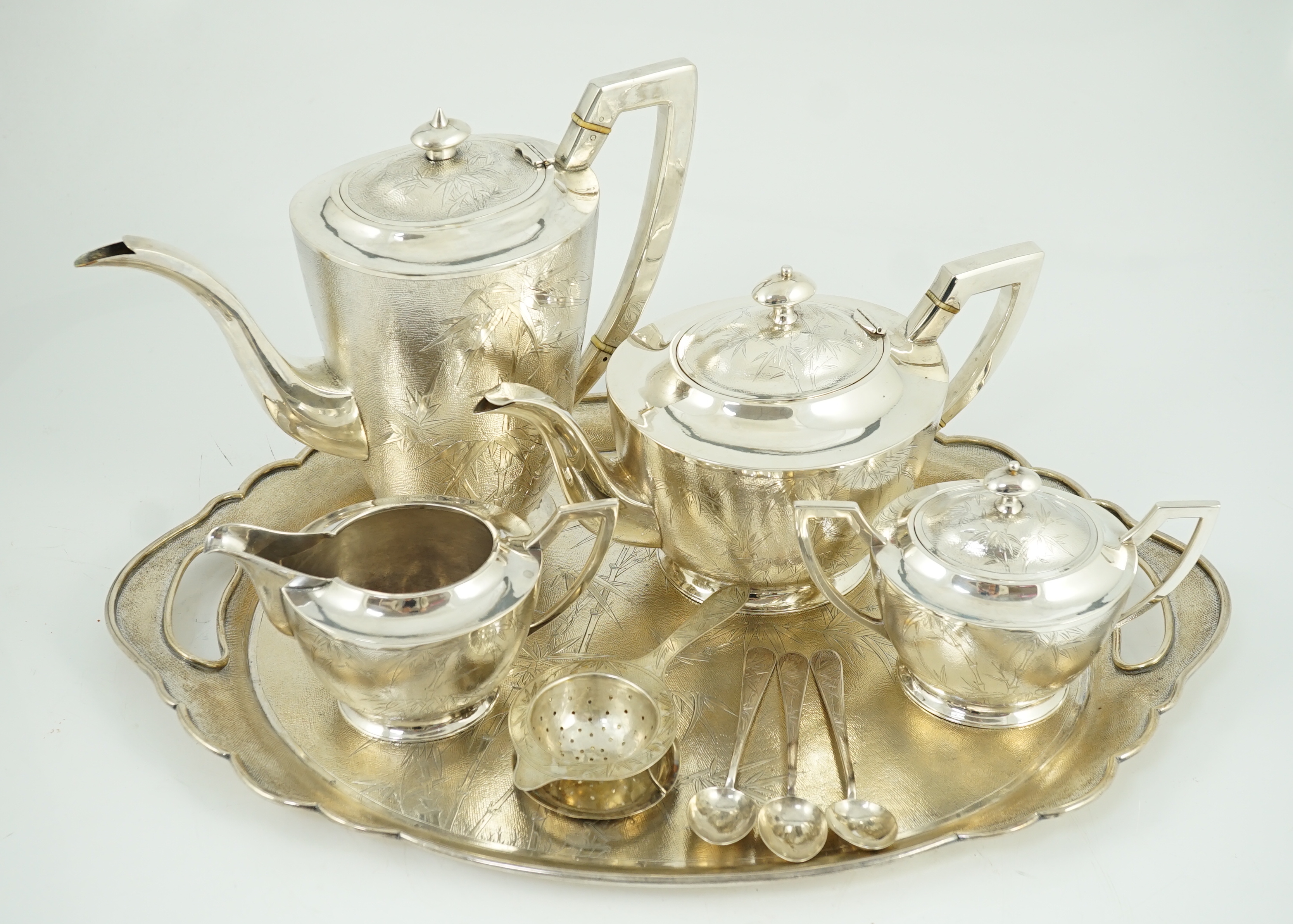 A late 19th/early 20th century Chinese Export sterling silver four piece tea and coffee service and matching oval tea tray, three teaspoons and a tea strainer, by Tack Hing, Hong Kong